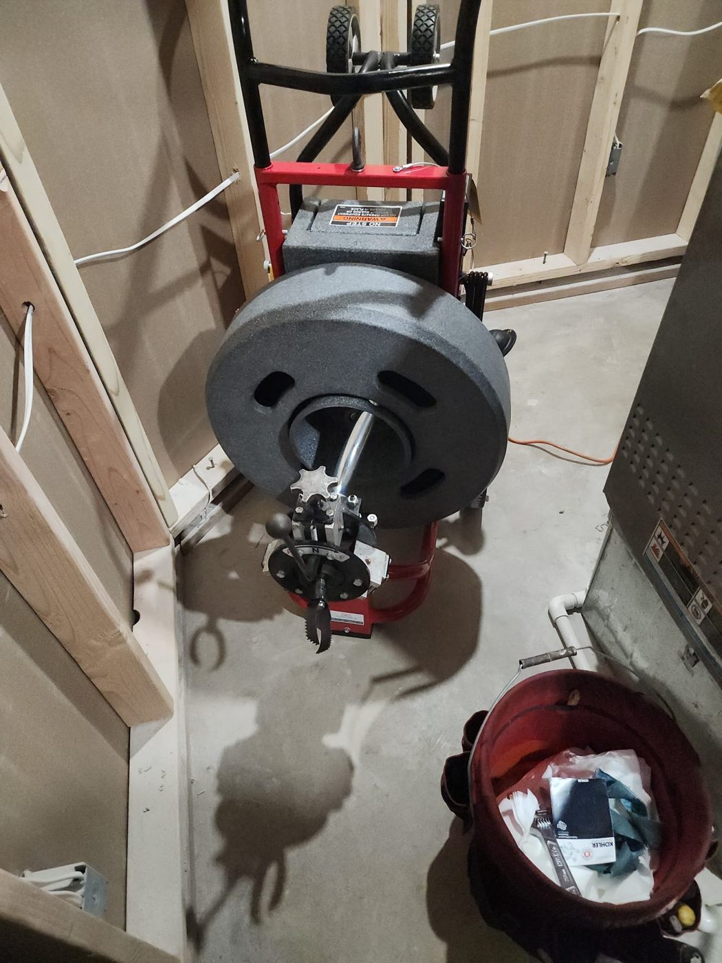 Drum auger machine clearing a stubborn drain line at a Denver, Colorado home